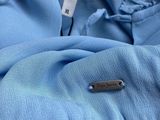 a tag on a blue shirt with a name tag attached to it