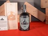 a bottle of liquor sitting next to a wooden box