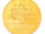 a gold coin with a design on it on a white background