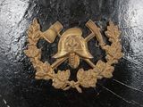 a black helmet with a gold emblem on it