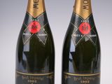 two bottles of moet and chandon champagne on a white background