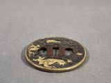 a gold and black coin with a horse on it