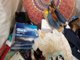 a pile of shoes and other items on a bed