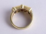 a gold ring with three diamonds on it