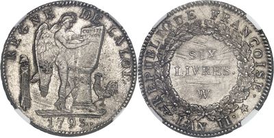 a close up of two silver coins on a white surface