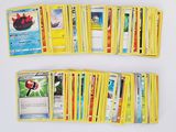 a lot of pokemon cards that are on the table