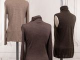 three mannequins in front of a white wall and a brown sweater on a mannequin stand
