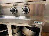 a stainless steel stove with two pots on top of it
