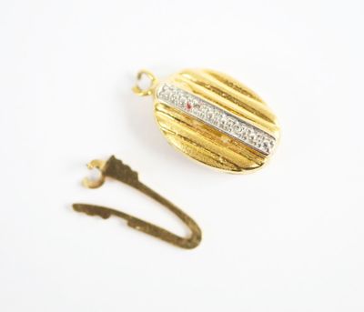 a close up of a gold locke with a diamond on it