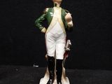 a figurine of a man in a uniform with a cane