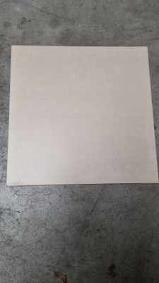 a piece of paper on the floor next to a pair of scissors