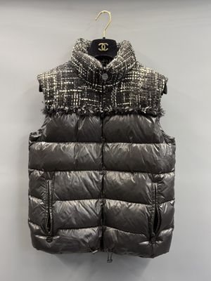 a close up of a black and white vest hanging on a wall