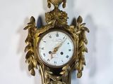 a clock that is hanging on the wall next to a wall
