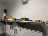 a metal shelf that has a bunch of papers on it