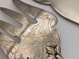 two forks and a knife on a white table