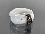 an image of a white and black ring on a table
