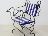 a blue and white striped chair with a bird on it