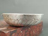 a silver bowl sitting on top of a red box