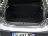the back of a silver car with its trunk open in a parking lot
