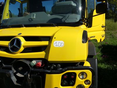 a large yellow truck that is parked in the grass