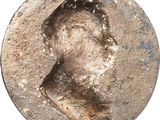a close up of a coin with a man ' s face on it