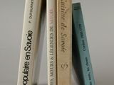 three books that are stacked on top of each other
