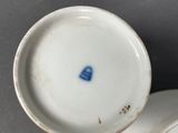a small cup and saucer sitting on a table
