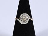a close up of a ring with a diamond in it
