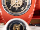a close up of a red car dashboard with a speedometer