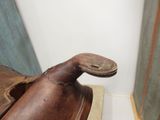 a brown shoe that is sitting on top of a mat