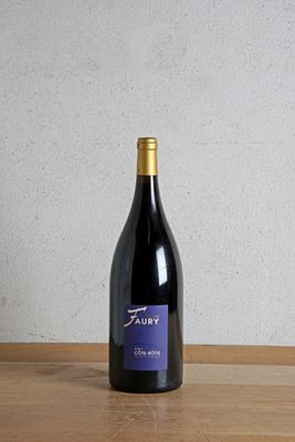 a bottle of wine sitting on top of a wooden table