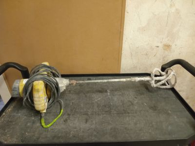 a black cart with a hose on it in a room