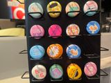 a display of buttons on a black rack in a store