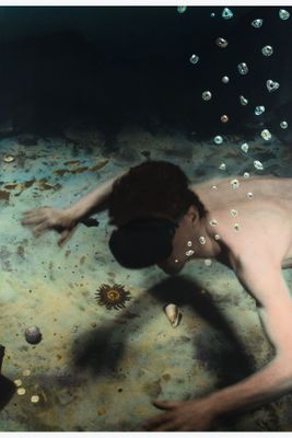 a man that is swimming in the water with bubbles