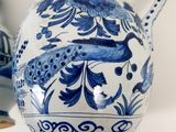 two blue and white vases with peacocks on them