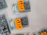 many different types of screws and nuts on the table