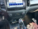 the interior of a car with a steering control and dashboard controls