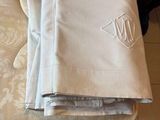 several folded napkins on top of a mattress in a room