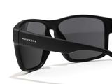 the sunglasses are black and have grey lenses on them