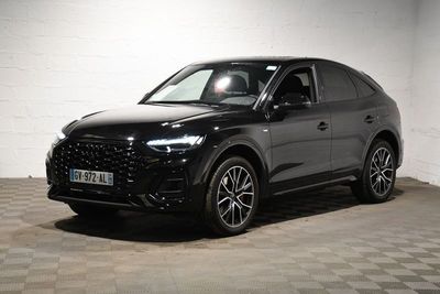 the black suv is parked on a checkered floor in a garage