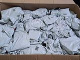 a cardboard box filled with a lot of silver items