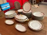 many plates and bowls sitting on a table in a room