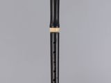 a flute with a black body and gold trim on a clear surface