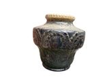 a vase that is sitting on a white surface