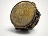 a close up of a ring with a gold coin on it