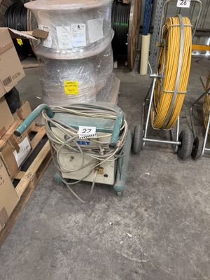 a stack of boxes and a cart in a warehouse