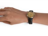 wrist shot of a woman ' s wrist with a watch on it