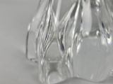 a glass vase with a flower inside of it on a table