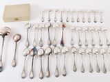 a lot of silver spoons and spoon spoons on the table