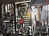 many tools hanging on the wall in the garage